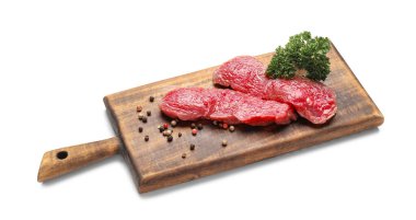 Wooden board with raw beef meat on white background