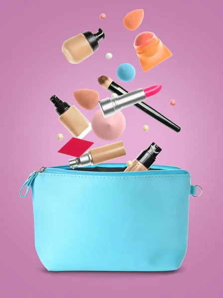 Flying decorative cosmetics with bag on color background