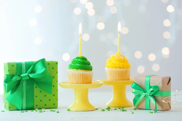 Stands Tasty Birthday Cupcakes Burning Candles Gifts Table Defocused Lights — Stock Photo, Image