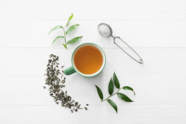 Composition Cup Tea Green Leaves Strainer Light Wooden Background — Stockfoto