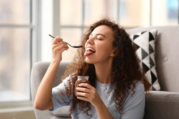 Young African American Woman Eating Chocolate Paste Home — Stock Photo, Image