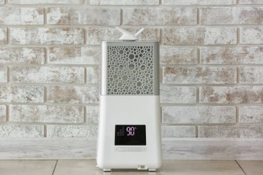 Tuğla duvarın yanında modern nemlendirici