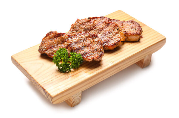 Wooden board with tasty beef steaks on white background