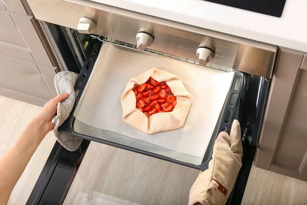 Woman Putting Baking Tray Uncooked Strawberry Galette Oven — Stock Photo, Image
