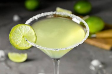 Glass with tasty daiquiri cocktail on grey background