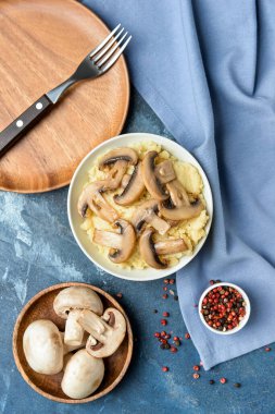 Composition with tasty mashed potatoes, mushrooms and peppercorns on color background