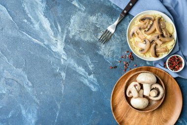 Composition with tasty mashed potatoes, mushrooms and peppercorns on color background
