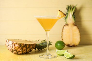 Arka planda bir bardak ananas kokteyli.
