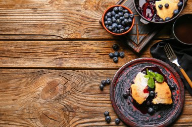 Composition with blueberry cobbler on wooden background