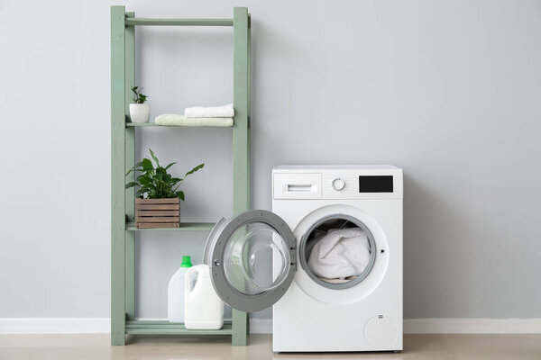 Interior of bathroom with modern washing machine
