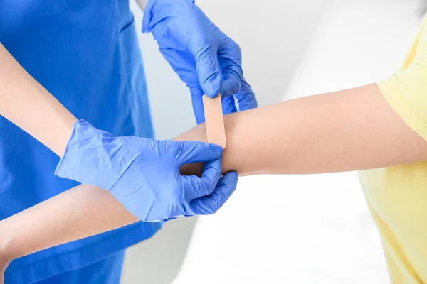 Nurse Applying Medical Patch Young Woman Arm Clinic — Stock Photo, Image