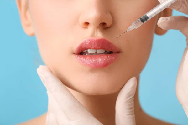 Young Woman Receiving Filler Injection Lips Color Background Closeup — Stock Photo, Image