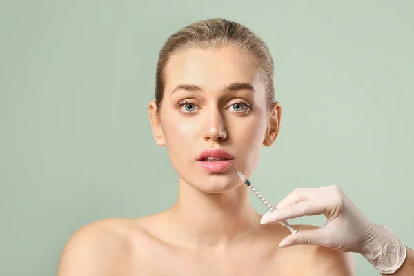Young Woman Receiving Filler Injection Lips Color Background — Stock Photo, Image