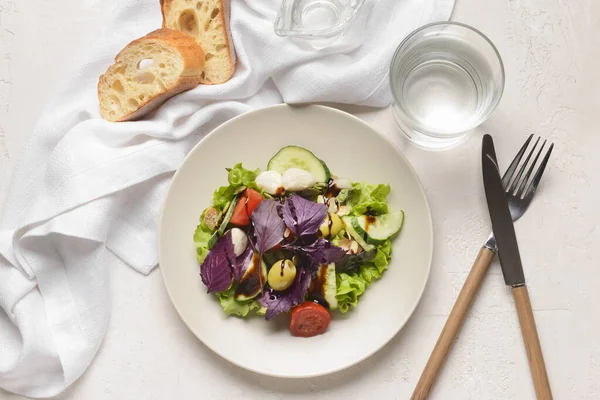 Plate Tasty Fresh Salad Bread Glass Water Light Background — Stock Photo, Image