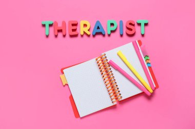 Renk arkaplan üzerinde dizüstü ve işaretleyici ile kelime THERAPIST