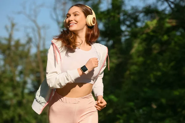 Sporty Young Woman Listening Music While Running Outdoors — Stock Photo, Image