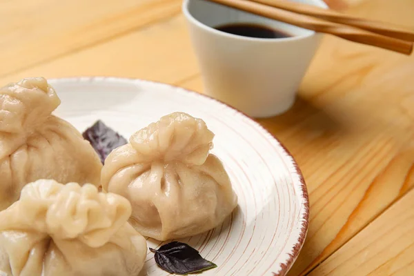 Plate Tasty Dumplings Chopsticks Bowl Sauce Wooden Background Closeup — Stock Photo, Image
