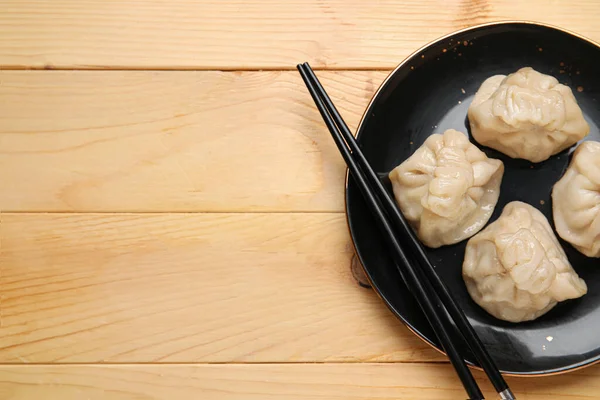 Plate Tasty Dumplings Chopsticks Wooden Background — Stock Photo, Image