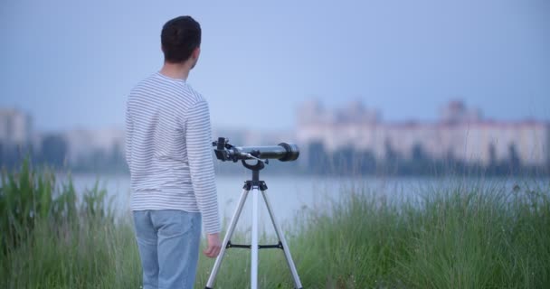 Young Man Looking Telescope Outdoors Evening — Stock Video