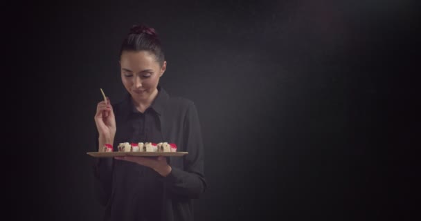 Schöne Junge Frau Isst Leckere Sushi Rollen Auf Dunklem Hintergrund — Stockvideo
