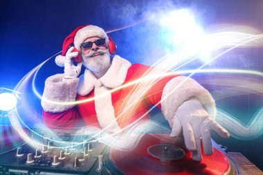 Havalı Noel Baba DJ kulüpte müzik çalıyor.