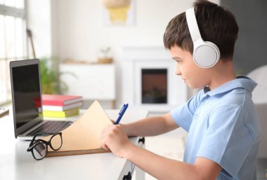 Küçük okul çocuğu evde online çalışıyor.