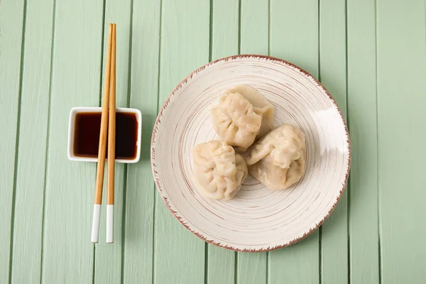 Plate Tasty Dumplings Chopsticks Bowl Sauce Color Wooden Background — Stock Photo, Image