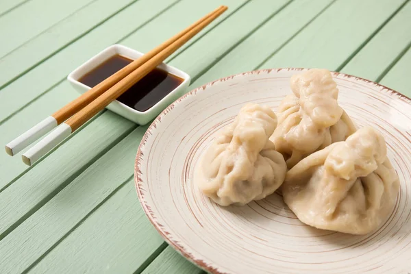 Plate Tasty Dumplings Chopsticks Bowl Sauce Color Wooden Background Closeup — Stock Photo, Image