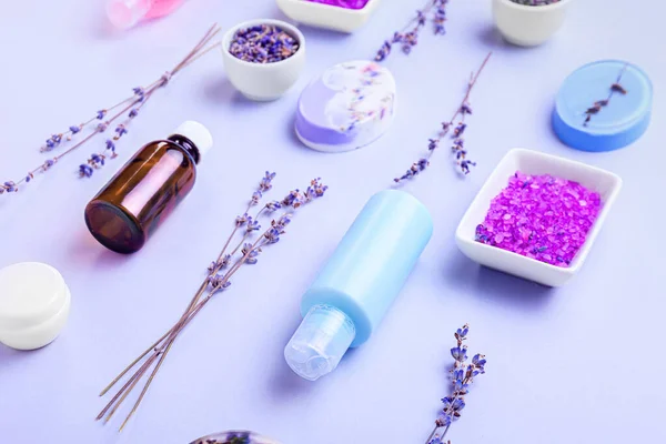 Composition with cosmetic products, sea salt and lavender flowers on white background