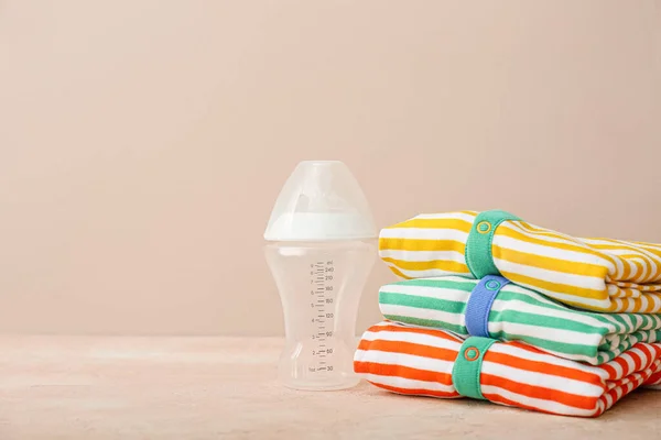 Stylish Baby Clothes Bottle Color Background — Stock Photo, Image