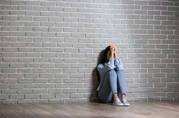Depressed Young Woman Sitting Brick Wall — Stock Photo, Image