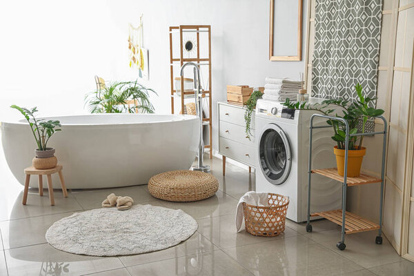 Interior of bathroom with modern washing machine