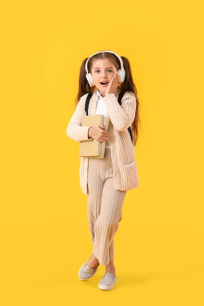 Surprised Little School Girl Books Headphones Color Background — Stock Photo, Image