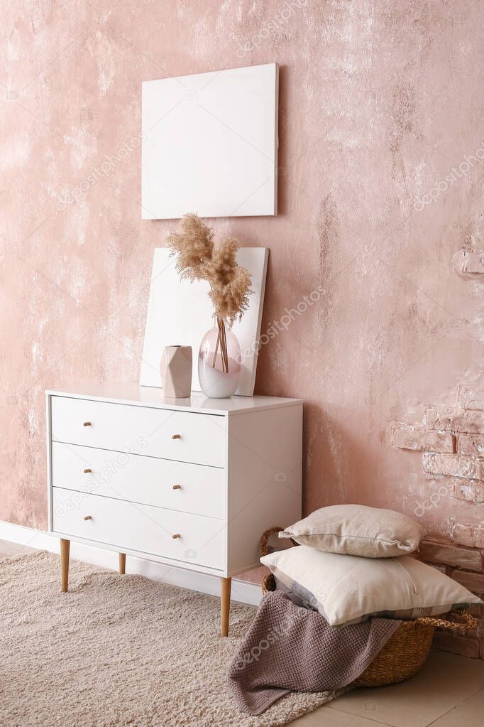 Interior of stylish room with chest of drawers