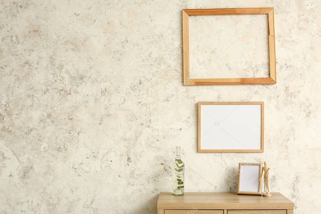 Wooden frames hanging on light wall