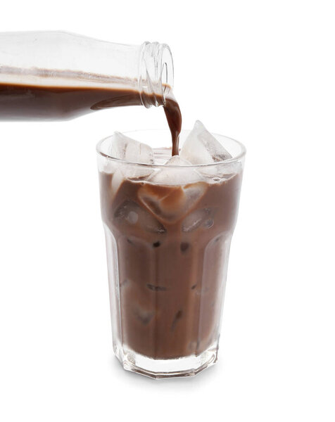 Pouring tasty chocolate milk into glass on white background