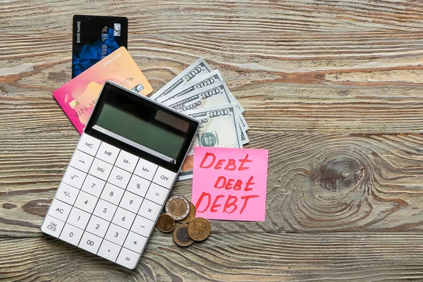 Paper Word Debt Money Calculator Wooden Background — Stock Photo, Image