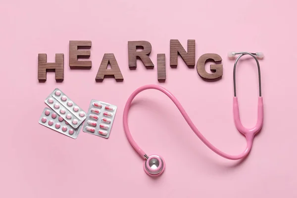 Word Hearing Stethoscope Pills Color Background — Stock Photo, Image