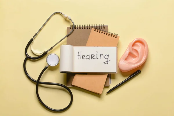 Notebook Word Hearing Stethoscope Color Background — Stock Photo, Image