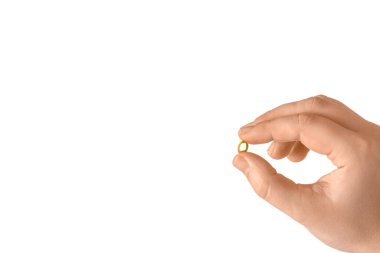 Beyaz arka planda kadın eli ve hapı