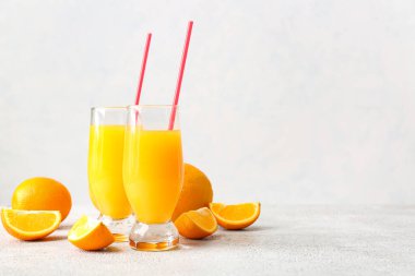 Hafif arka planda bir bardak lezzetli portakal suyu.