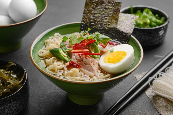 Koyu arkaplanda tavuk olan lezzetli bir Çin çorbası.