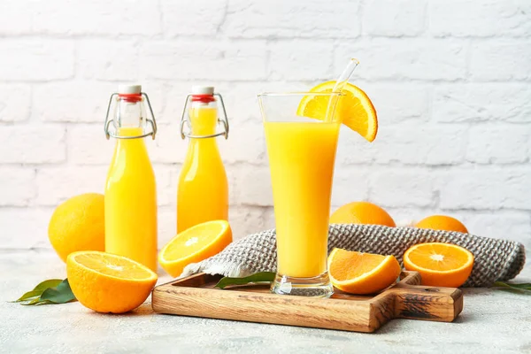 Bottles Glass Tasty Orange Juice Light Background — Stock Photo, Image