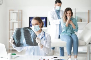 Klinikteki akciğerlerinin röntgen görüntüsüne sahip kadın doktor.