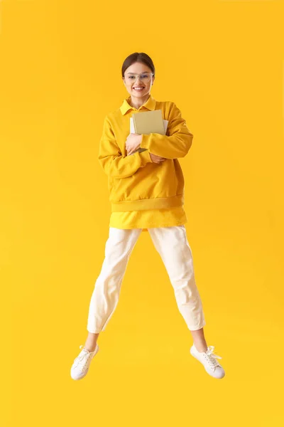 Jumping Young Woman Books Color Background — Stock Photo, Image