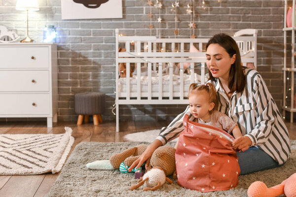 Mother and little baby playing at home