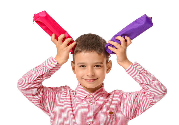 Little boy with pencil cases on white background