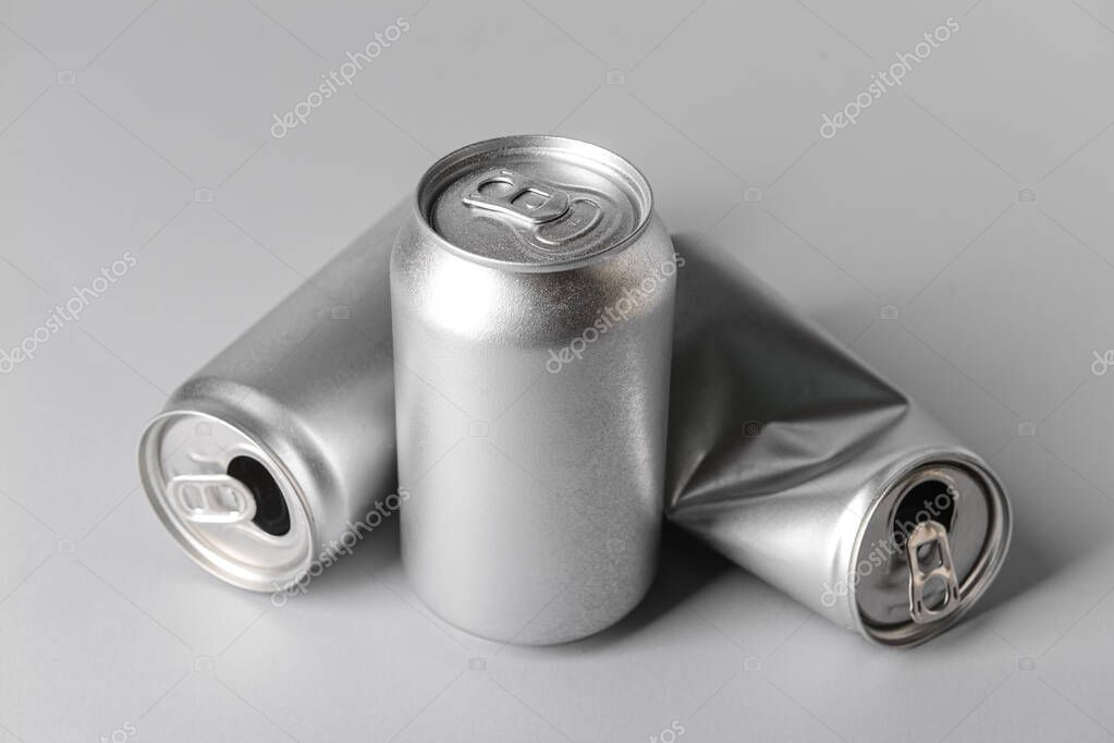 Cans of soda on grey background