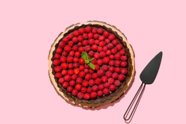 Renkli ahududu turtası ve spatulası olan tahta