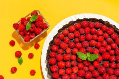 Lezzetli ahududu turtası ve renkli arkaplanda nane şekeri olan tahta